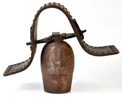 Lot 372 - A vintage Continental cow bell on a wooden...
