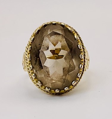 Lot 677 - A 9ct gold smoky quartz dress ring, size L,...