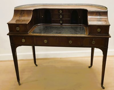 Lot 808 - A 20th century mahogany writing desk having a...
