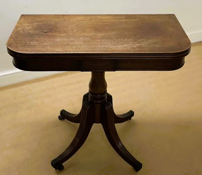 Lot 841 - A mahogany swivel top card table, raised on...