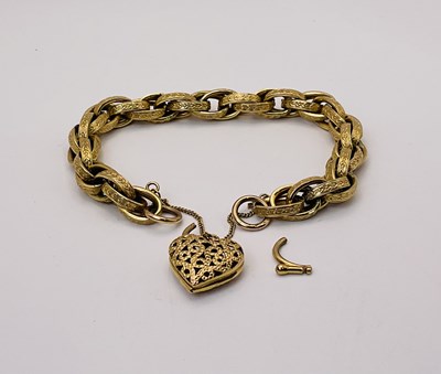 Lot 522 - A yellow metal bracelet with padlock charm,...