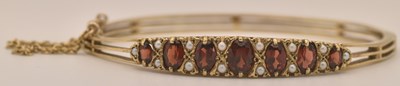 Lot 1412 - A 9ct yellow gold garnet and seed pearl set...