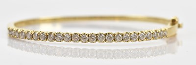 Lot 93 - A yellow metal hinged snap bangle set with...