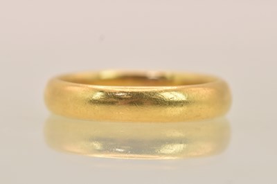 Lot 1218 - A 22ct gold band ring, size N, approx 4.63g.