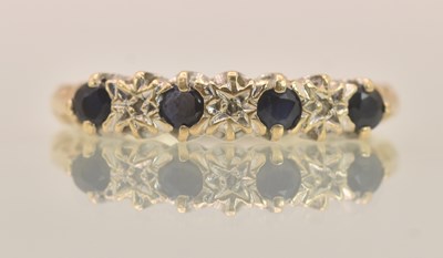 Lot 1294 - A 9ct yellow gold diamond and sapphire set...