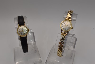 Lot 597 - TISSOT; two vintage manual wind gold plated...