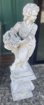 Lot 763 - A reconstituted concrete boy with a basket,...