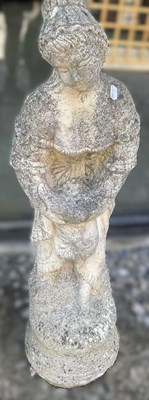 Lot 765 - A reconstituted concrete girl with bird,...