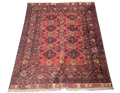 Lot 130 - A large hand woven wool pile Persian style red...