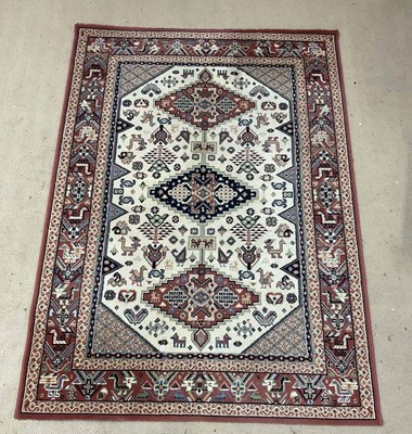 Lot 888 - A machine woven Persian style rug, with a...