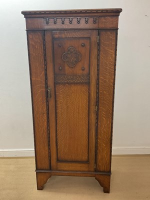 Lot 847 - An early 20th century oak hall cupboard with...