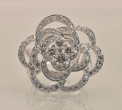Lot 1196 - An 18ct white gold diamond set pierced flower...