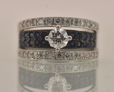 Lot 1199 - An 18ct white gold sapphire and diamond set...