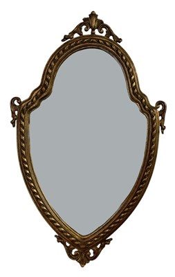 Lot 102 - A modern ornately gilt framed bevelled glass...