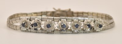 Lot 1404 - An 18ct white gold bracelet, with seven...