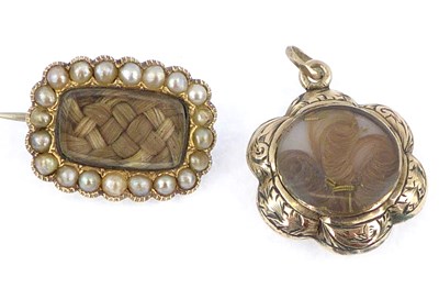 Lot 1002 - Two 19th century mourning brooches, one...