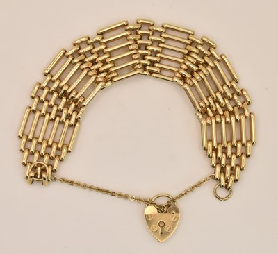 Lot 1402 - A 9ct yellow gold six bar gate bracelet,...