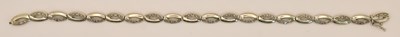 Lot 1429 - A 9ct white gold bracelet, with oval white...