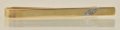 Lot 1369 - A 9ct yellow gold tie clip set with two tiny...