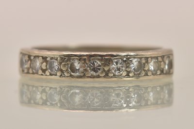 Lot 1234 - An 18ct white gold diamond set half eternity...