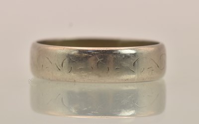 Lot 1238 - An 18ct white gold band ring, with D-shaped...