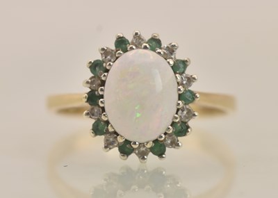 Lot 1268 - A 9ct yellow gold opal, diamond and emerald...