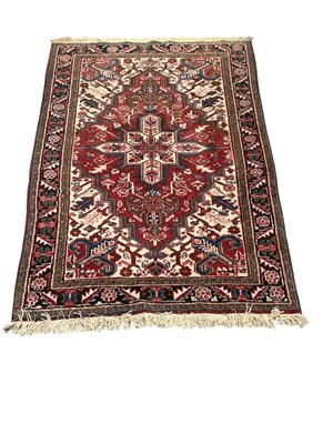 Lot 132 - A modern hand woven wool pile red ground...