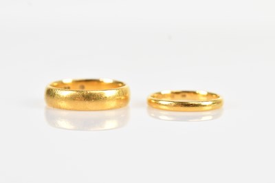 Lot 394 - Two 22ct gold wedding bands, size O and K,...