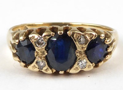 Lot 954 - A 9ct gold sapphire and diamond ring, three...