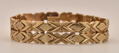 Lot 1418 - A 9ct yellow gold flat bracelet made up of two...