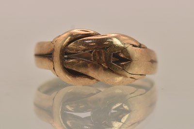 Lot 1273 - A 9ct rose gold buckle ring, size M, approx...