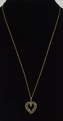 Lot 1348 - A 9ct emerald and diamond open heart shaped...