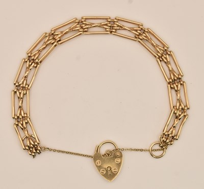 Lot 1420 - A 9ct yellow gold X-link gate bracelet, united...