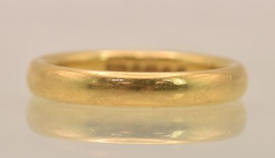 Lot 1224 - A 22ct yellow gold thin band ring, size J,...