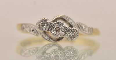 Lot 1277 - An 18ct yellow gold illusion set three stone...