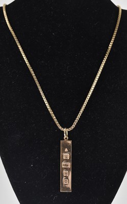 Lot 1298 - A 9ct hallmarked gold ingot pendant, length...