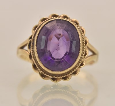 Lot 1289 - A 9ct yellow gold bezel set amethyst stone...