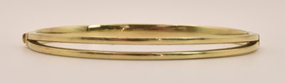 Lot 1425 - A 9ct yellow hollow gold hinged bracelet, the...