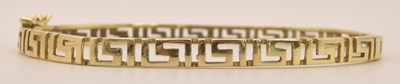 Lot 1417 - A 14ct yellow gold hinged bracelet, with...