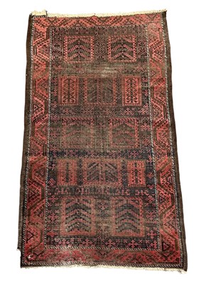 Lot 123 - A hand woven woollen ground red Baluchi carpet,...