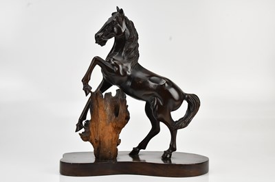 Lot 617 - A carved hardwood horse, on plinth base,...