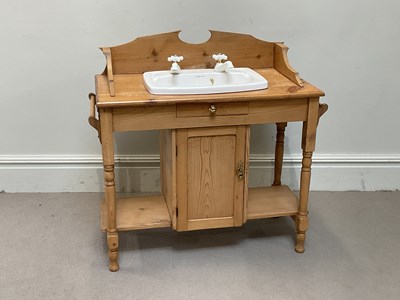 Lot 68 - An old pine washstand with raised back above a...