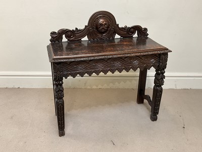 Lot 165 - A late 19th century carved oak hall table,...