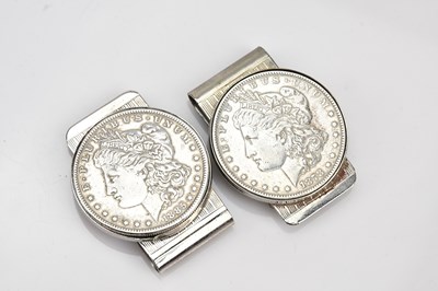 Lot 600 - Two silver dollar coins, mounted on money...