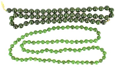 Lot 1037 - Two early 20th century Chinese jade-style bead...