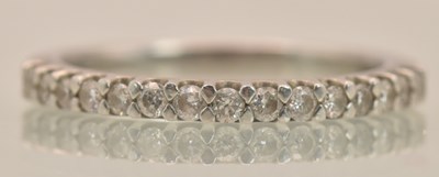 Lot 1230 - A platinum (950) half eternity ring set with...