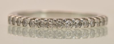 Lot 1231 - A platinum (950) half eternity ring set with...