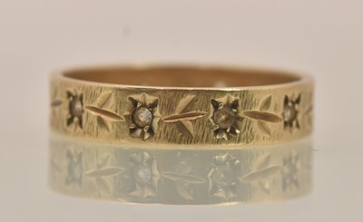 Lot 1283 - A 9ct gold band ring with floral set tiny...