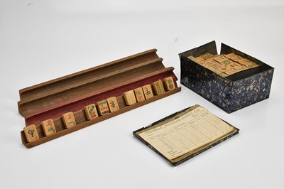 Lot 1168 - A vintage Mahjong set in a black metal...