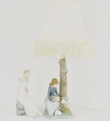 Lot 681 - NAO; a porcelain table lamp with girl and...